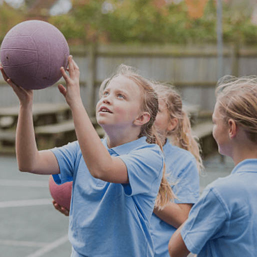 School child playing netball